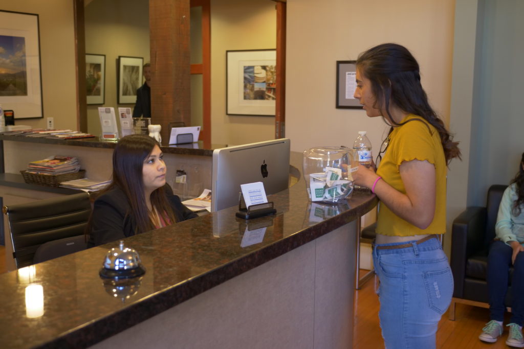 Dr. Lees staff talking with a patient